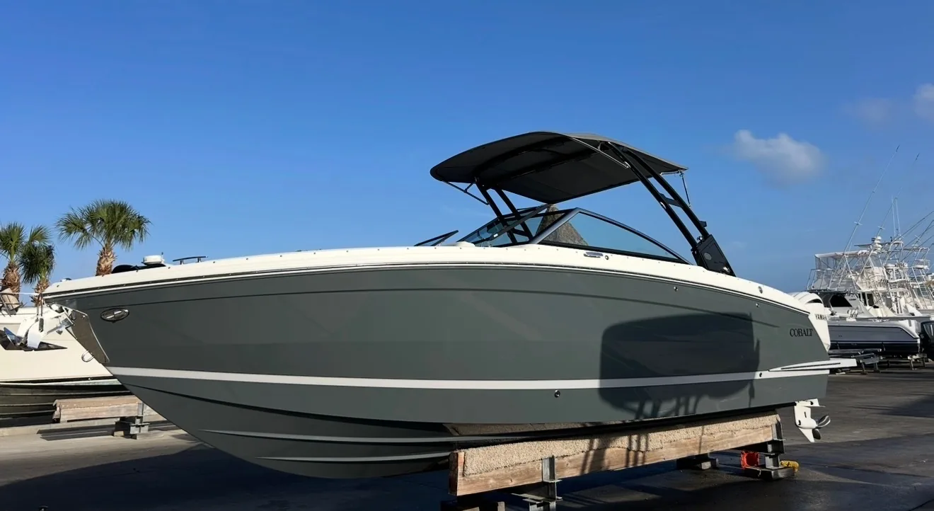 Wake boat with tower on its trailer after an exterior detail
