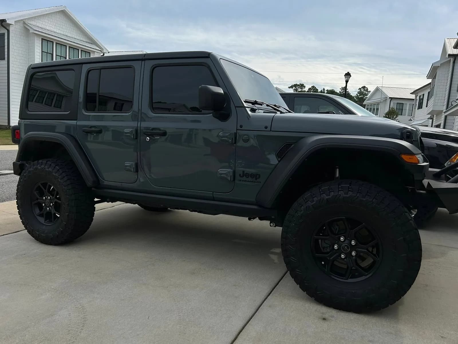 Dark grey Jeep Wrangler with clean tires after an exterior detail